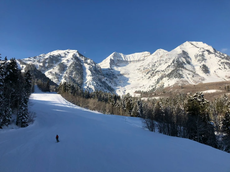 a person standing in snow on a ski slope