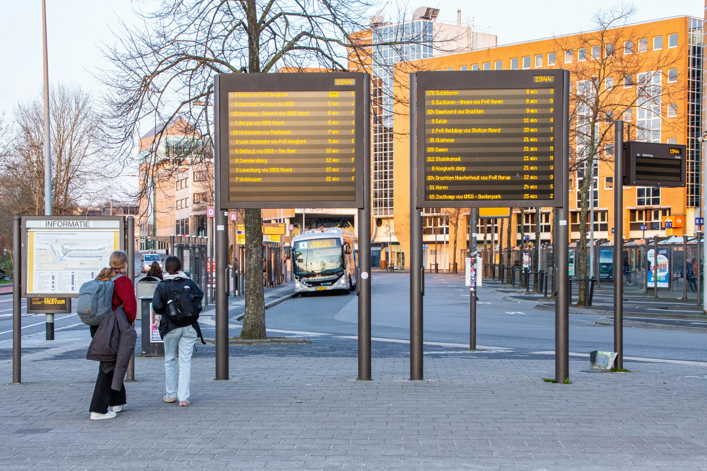 three people are standing in front of large signs that show the information