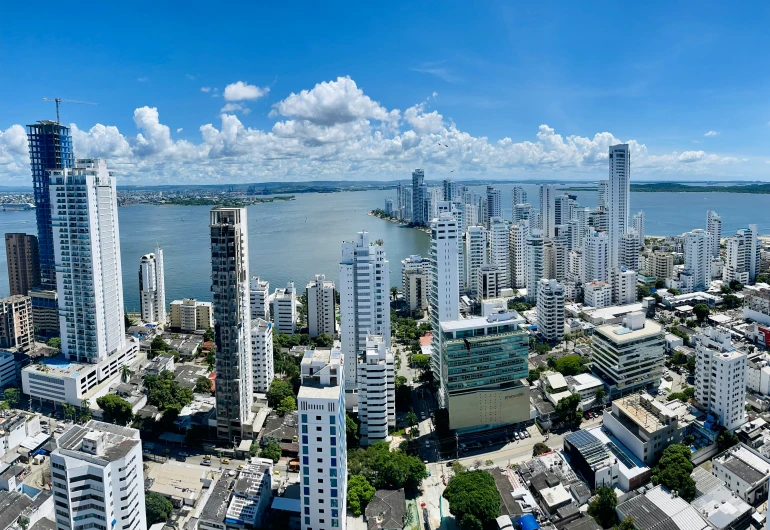 some tall buildings near the ocean and a body of water