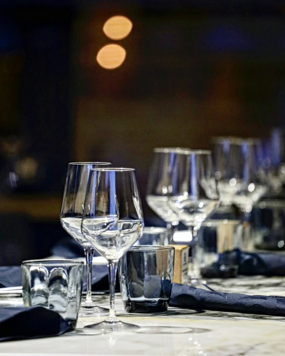 a table set for three with wine glasses