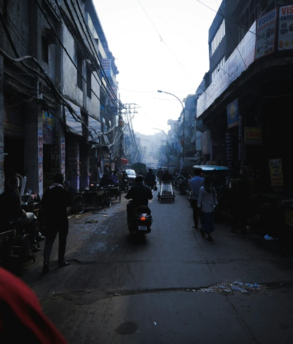 some people on motorcycles and buildings and a street