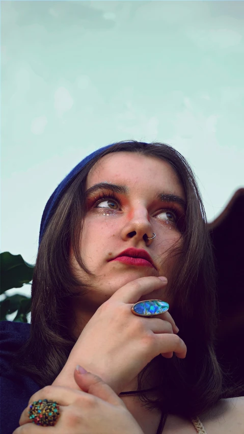 a woman sitting outside with her eyes closed