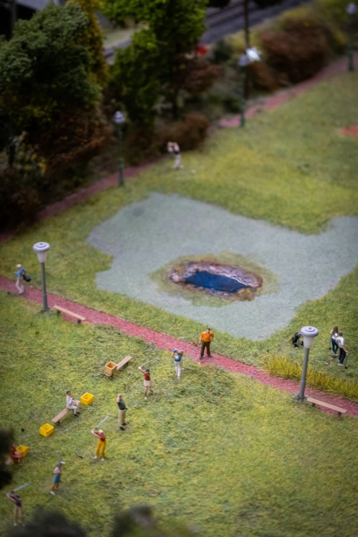 an aerial view of a park with a pond