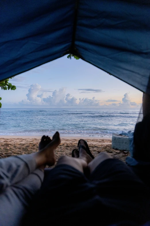 two people in a tent on the beach