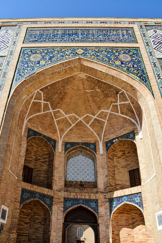 an ornate archway on the outside wall of a building