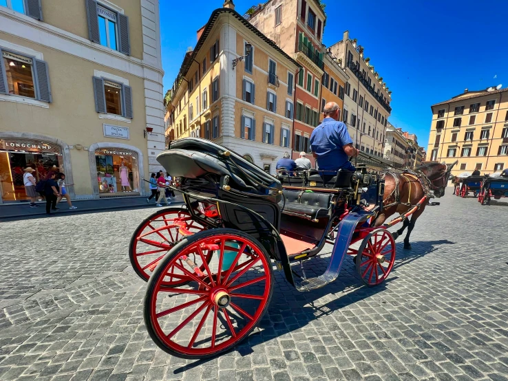 a man standing on a cobblestone sidewalk in front of a carriage