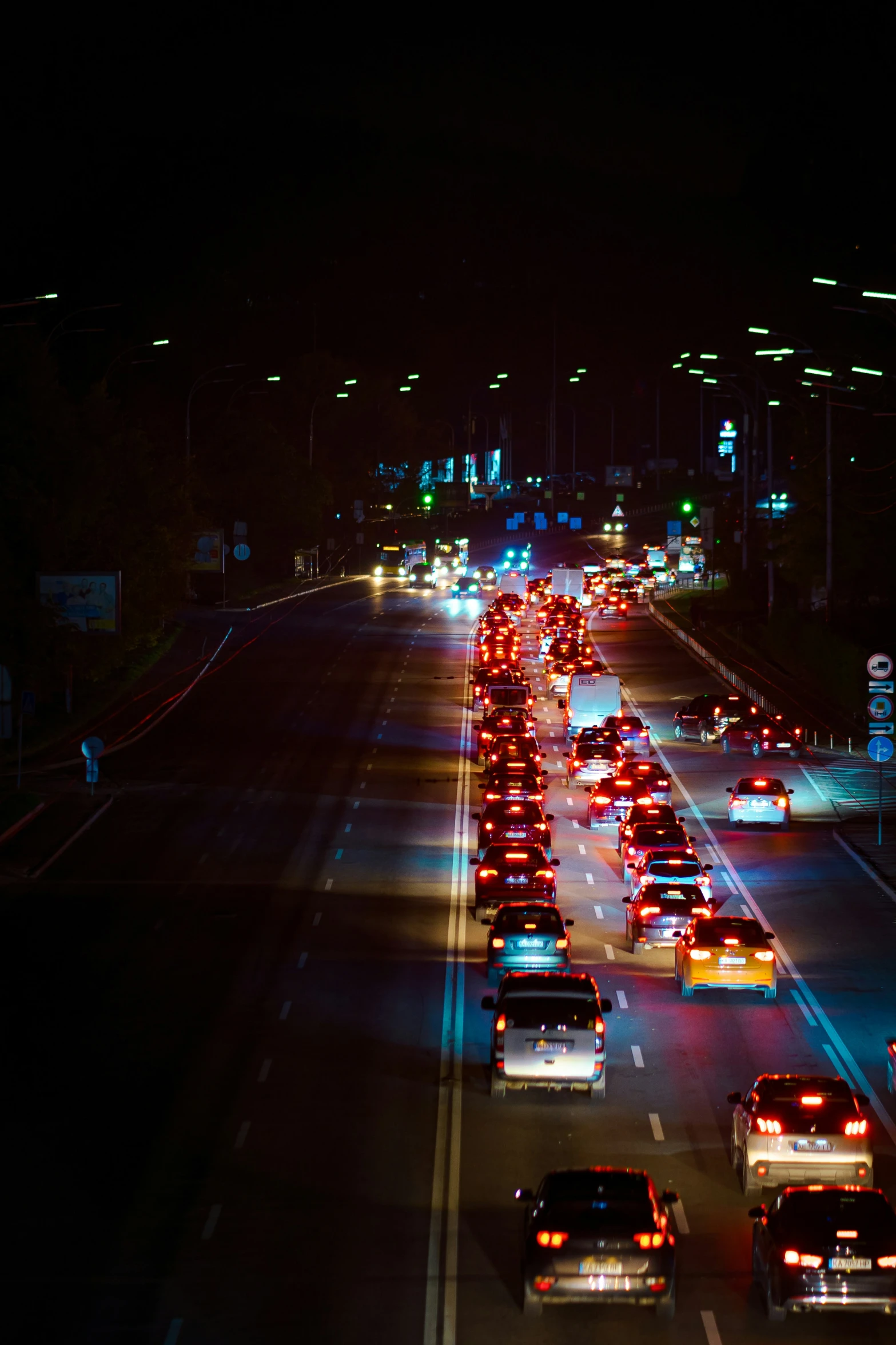 an array of vehicles driving on the highway at night