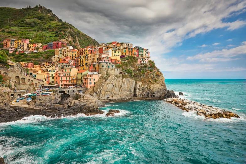 the village has a rock - strewn cliff over the ocean