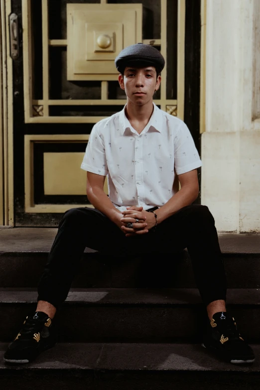 a young man is sitting on the steps