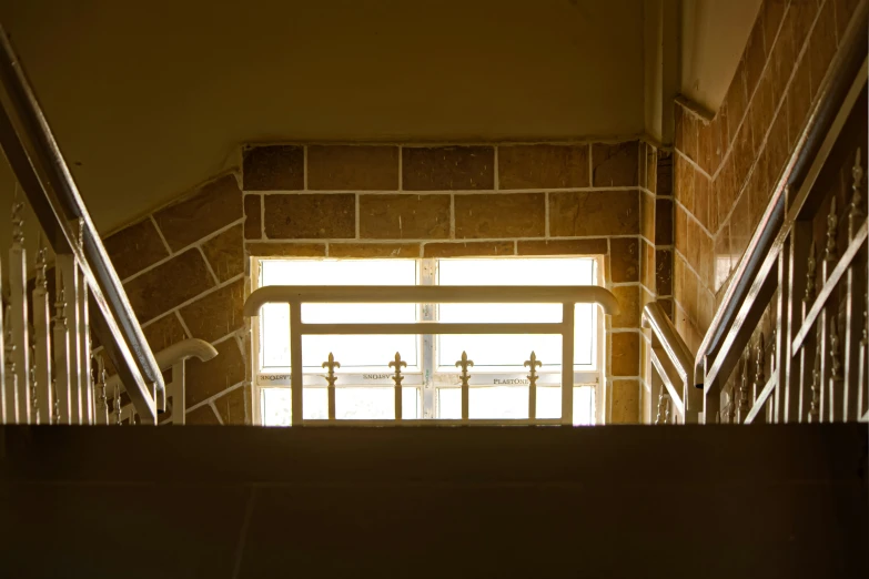 two stair railings, and a door to an open area