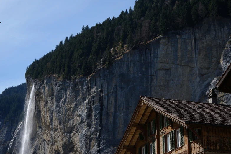 a house next to the waterfall of water