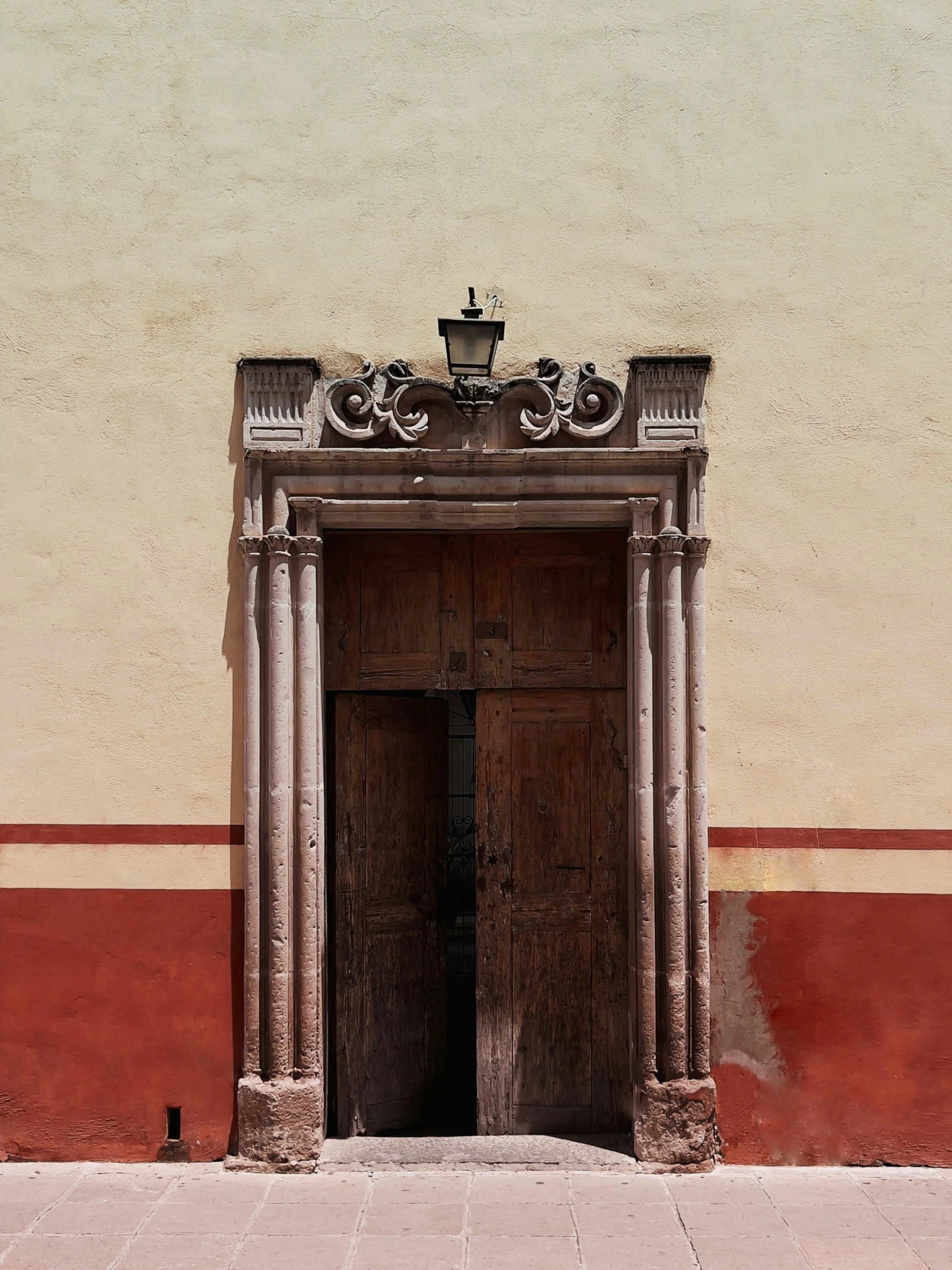 an old building with two large doors that have columns