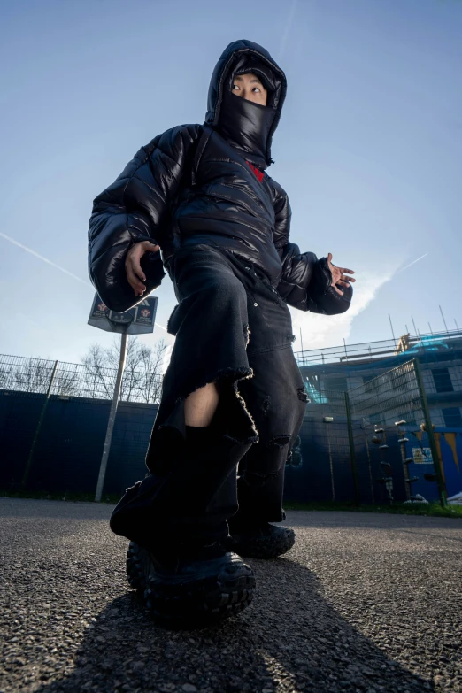 a young  wearing a full face snowboard suit