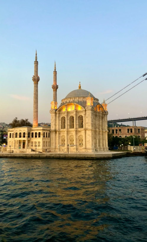 a mosque next to a bridge in the city