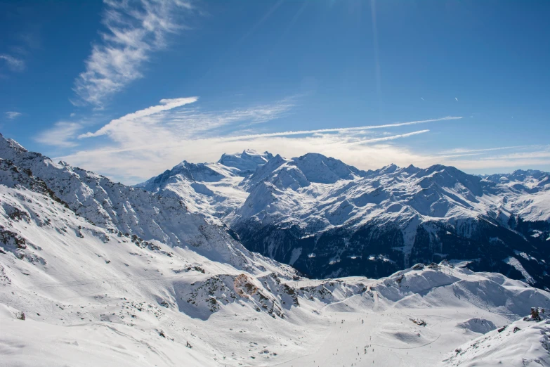 the sun shines on some snowy mountains and snow