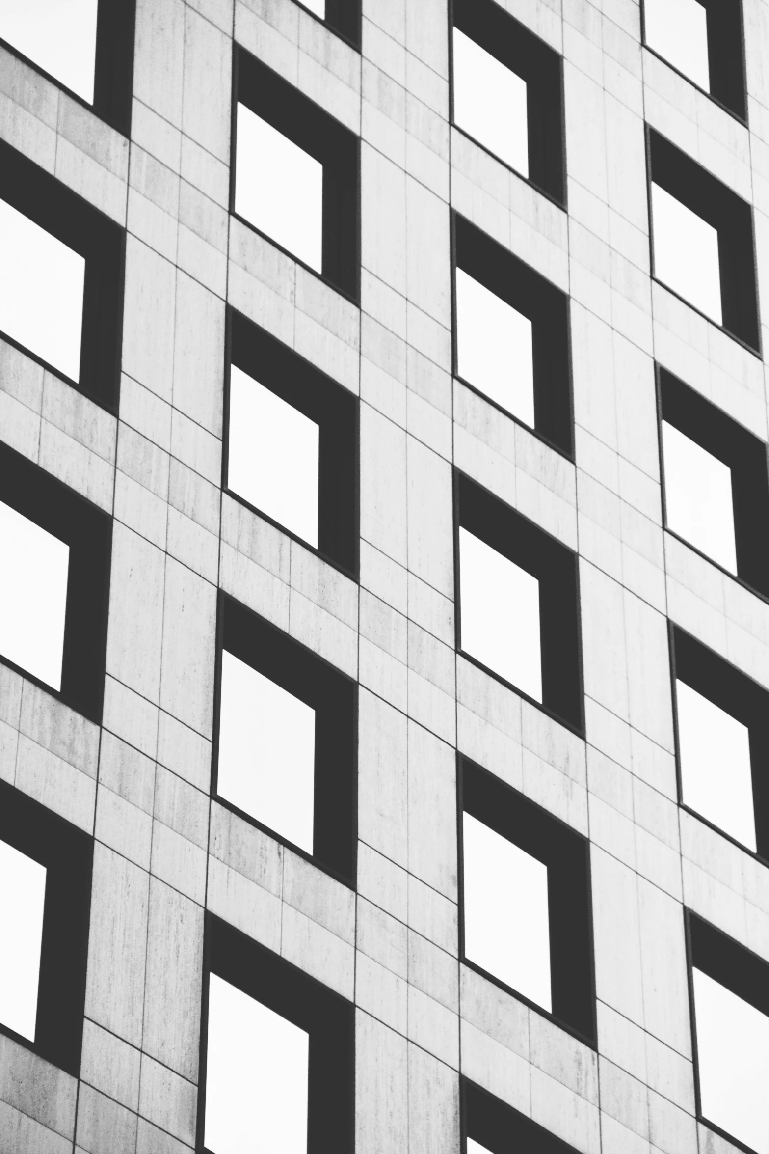 the bottom part of an apartment building with broken windows