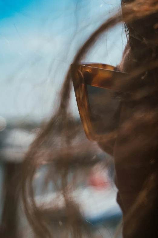 the woman wearing glasses is looking at a traffic light