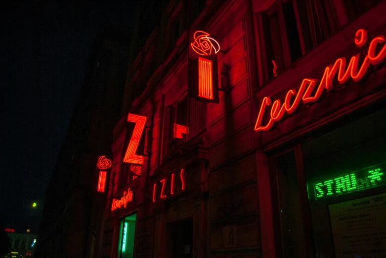 an outside s of a restaurant at night with neon signs on it