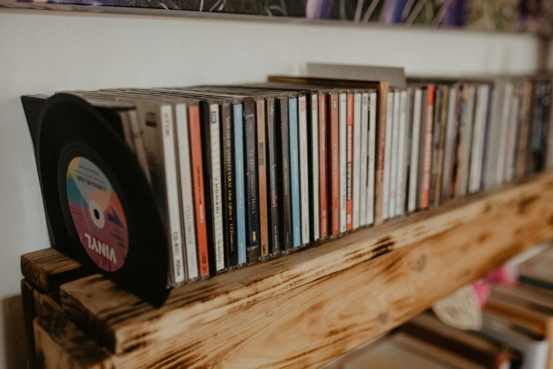 various album's sit on the shelf with other cds