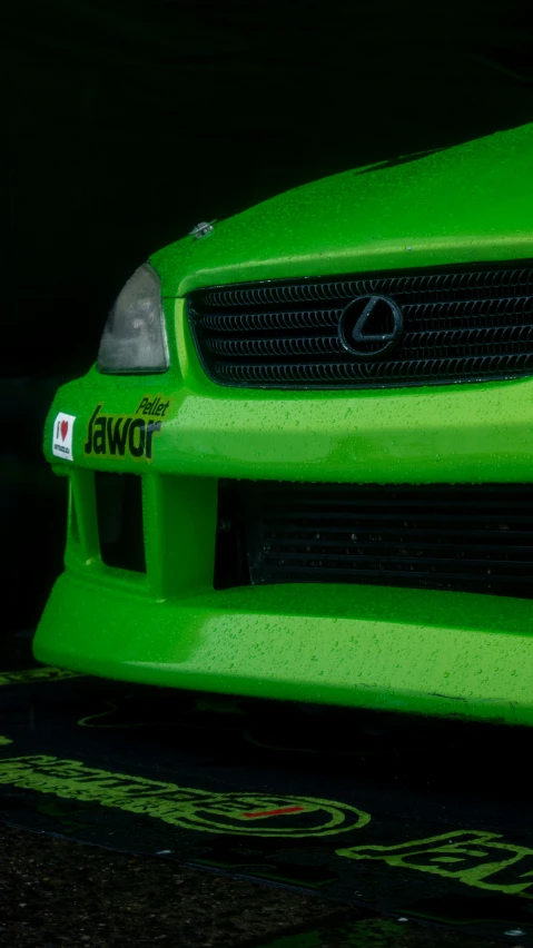 a close up of the front end of a green car