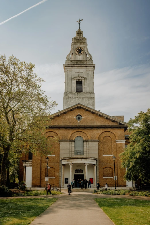 an old brick church with a tower has a steeple and is on display