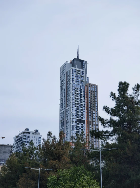 a very tall building sitting next to a forest