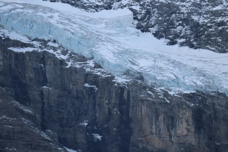 a mountain side that has a bunch of snow on it