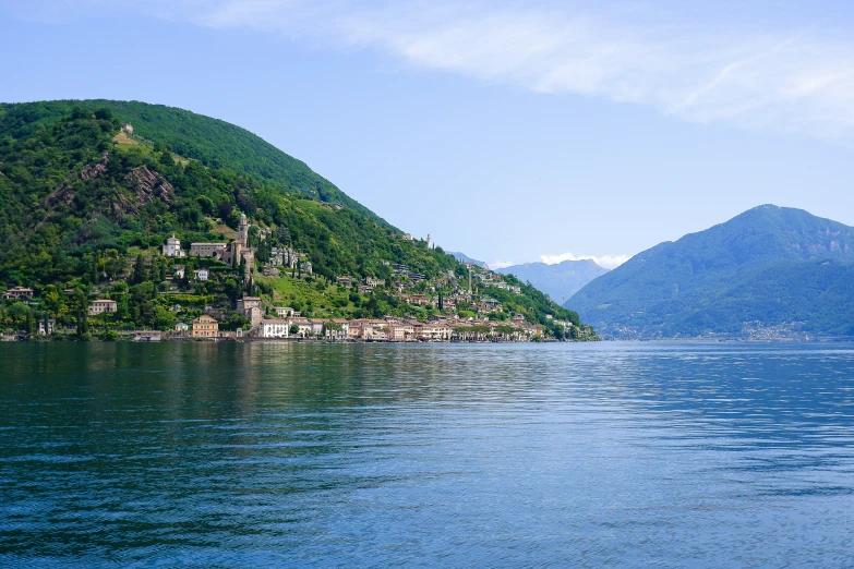 the water has some hills and buildings on it