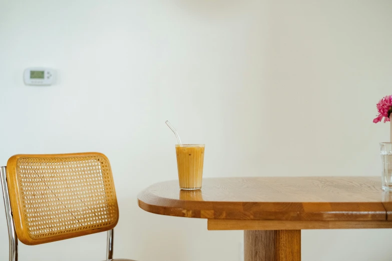 two chairs sitting at a table with a glass on top