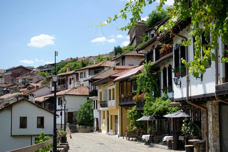 a cobblestone road with many small buildings in the distance