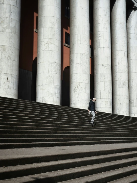 an image of a boy in black jacket running up stairs