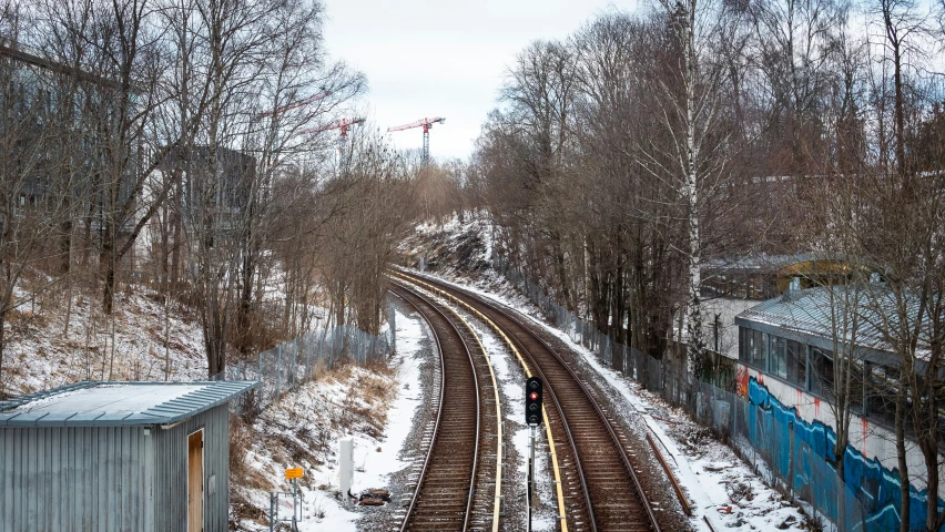 a train traveling down tracks in the snow