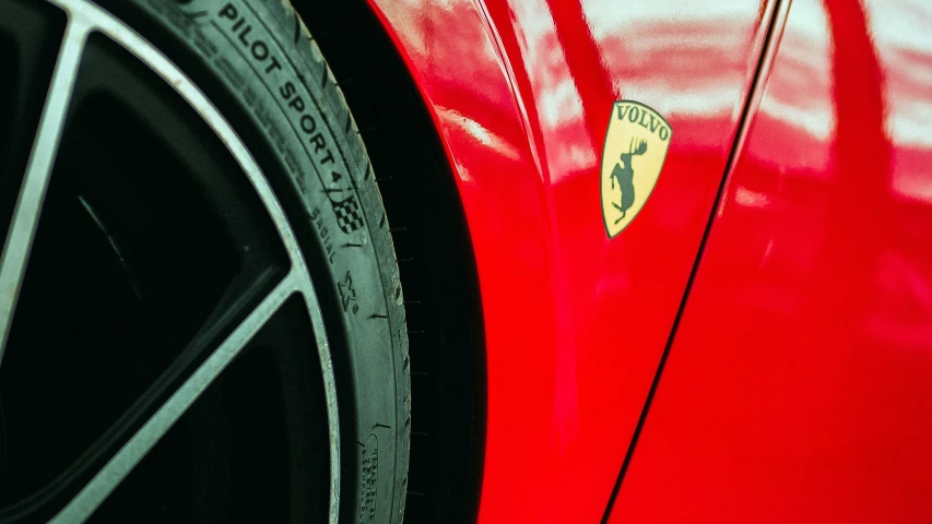 the back end of a red car with a ferrari logo