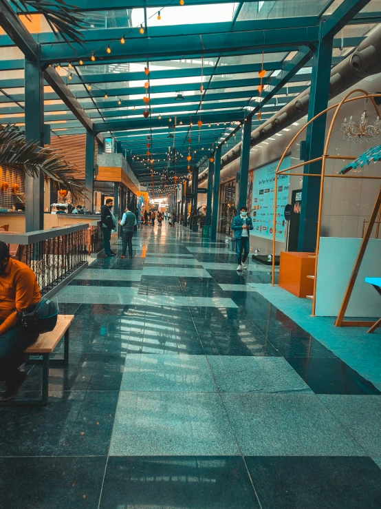 a man is sitting on a bench in the middle of a walkway