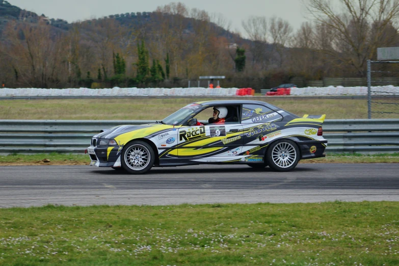 a yellow and gray car on a track