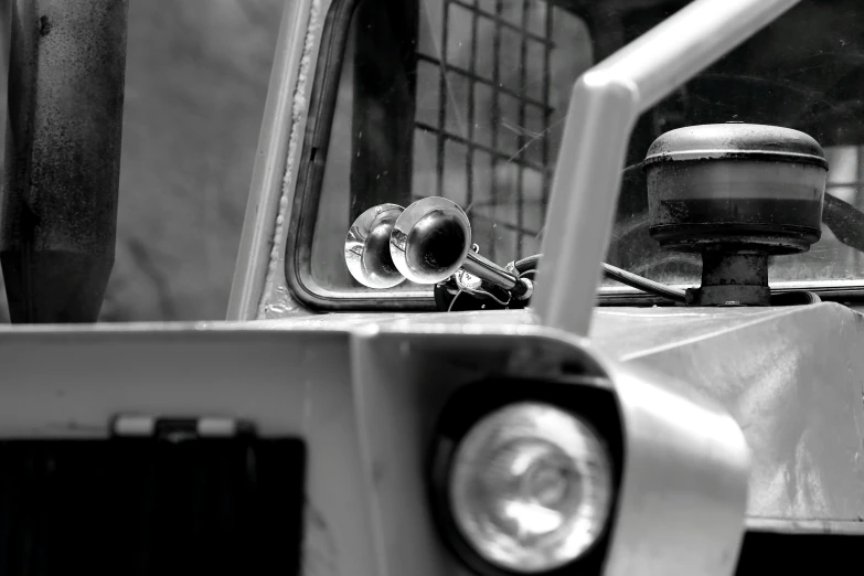 a car parked near a metal pole with two windows