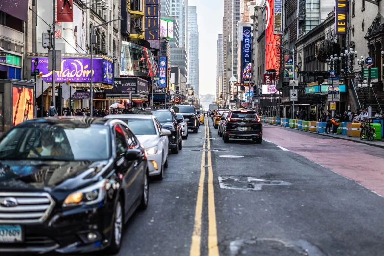 cars driving on a busy city street near skyscrs