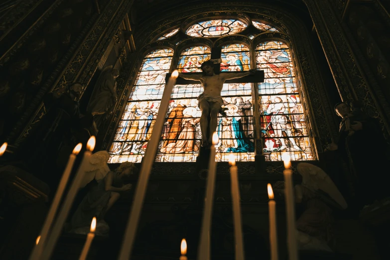 a church that has several candles near a wall