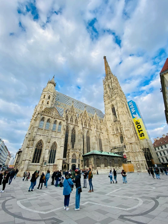 a bunch of people walking around in front of the cathedral