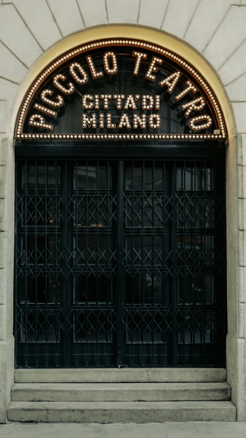 an entrance to a theatre that has lights above the entrance