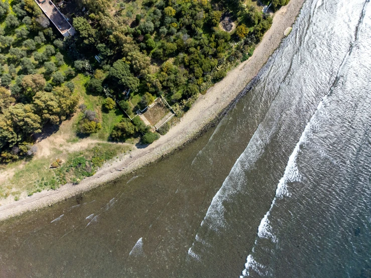 a view of a river from the air, showing a few boats on it