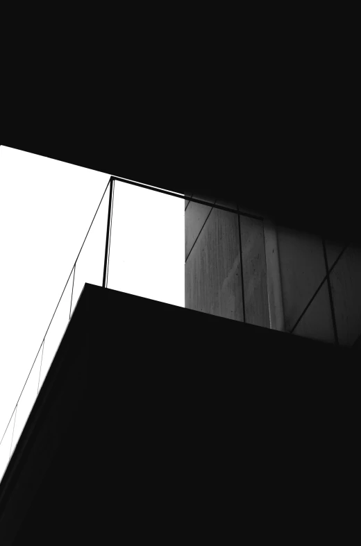 a silhouette view of two tall buildings with a skylight above