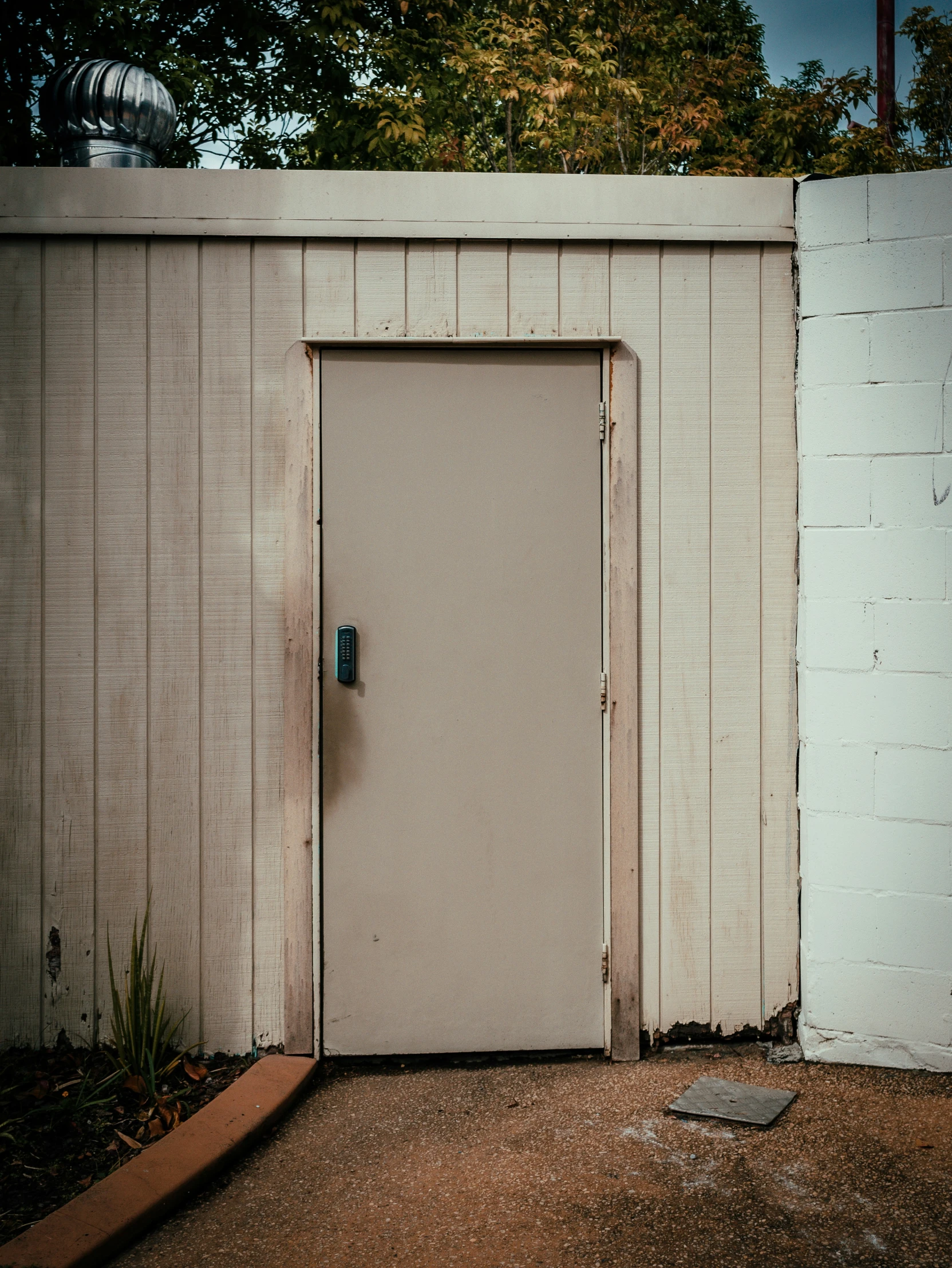 a door with a piece of plywood in front of it