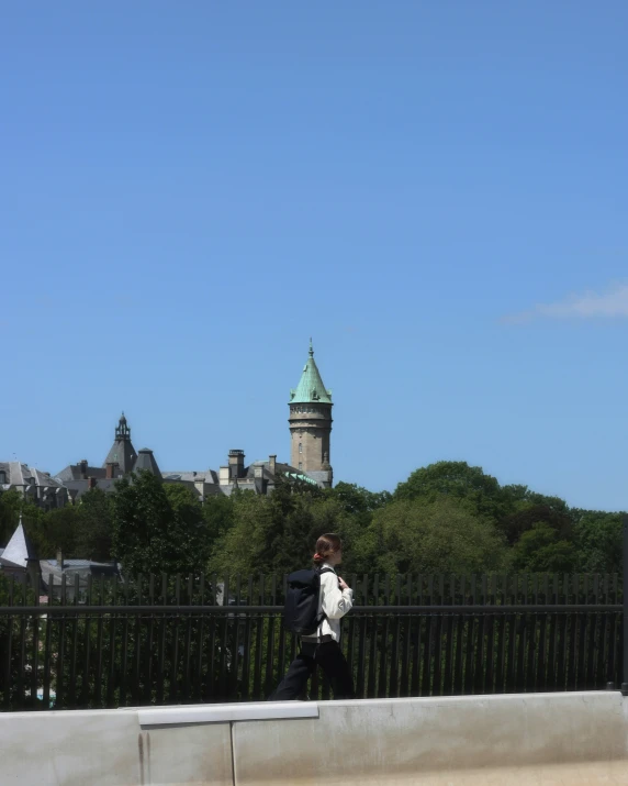 person in the foreground with a clock tower behind them