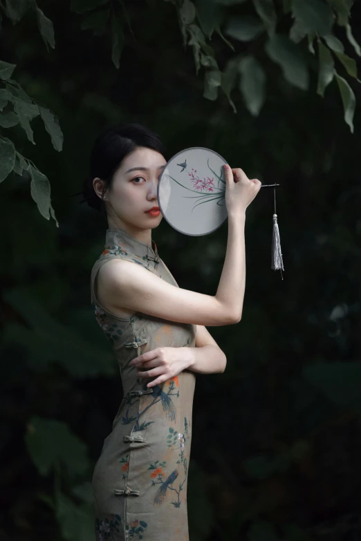 woman dressed in traditional chinese clothing holding a frisbee