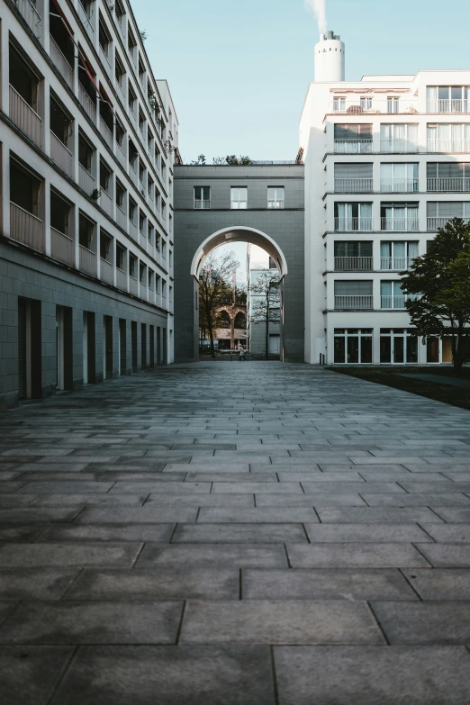 a large building has an archway with a clock tower