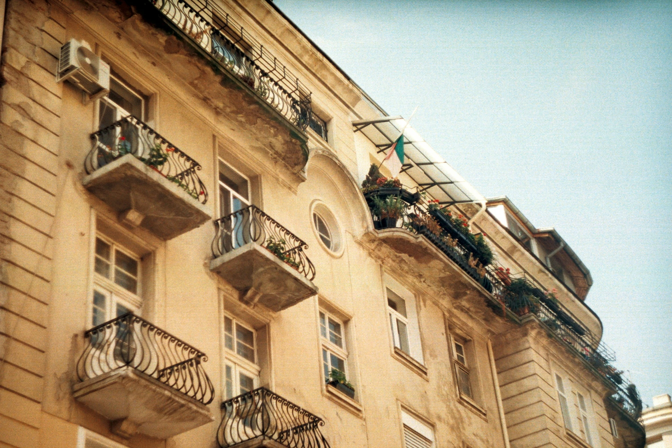 an apartment building with iron balcony railing and balconies