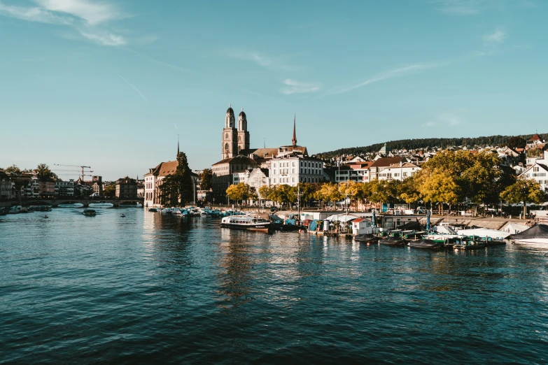 a river with a boat traveling along it, surrounded by trees and buildings