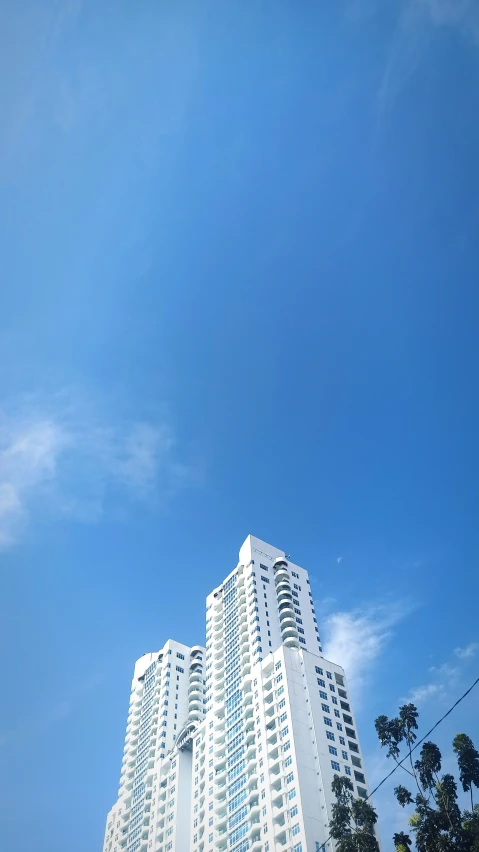 tall white building with lots of windows on top