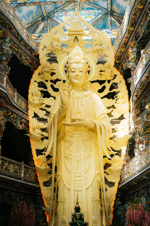 the statue is decorated with flowers and a skylight above it